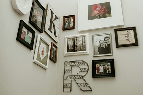Family photos printed and displayed on a wall
